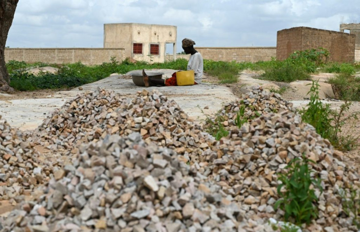 Sixteen people have died in an attack on a mosque in Burkina Faso's volatile north, security sources said; A woman, who is among the 300,000 internally displaced because of jihadist violence in northern and eastern Burkina Faso, is pictured September 17, 