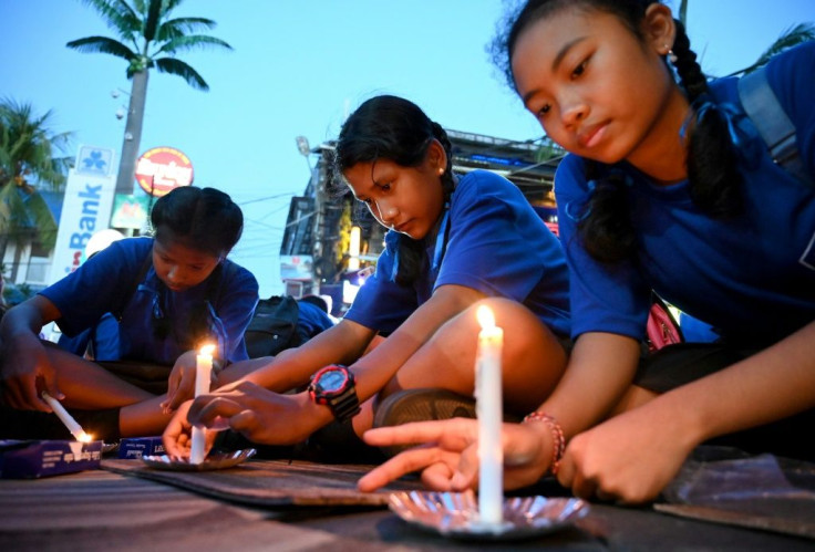 School children light candles during a memorial service to commemorate the 2002 Bali bombings which killed 202 people, most of them foreign tourists