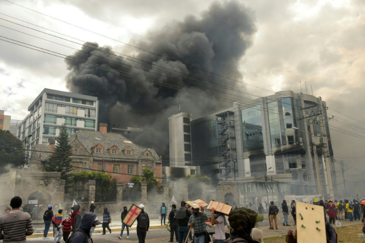 Smoke rises from the building housing the General Comptroller's office in Quito on October 12, 2019