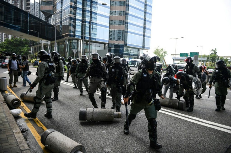 Police clear barricades left by protestors. Clashes between police and activists were less intense than at the start of October when the city was virtually shut down