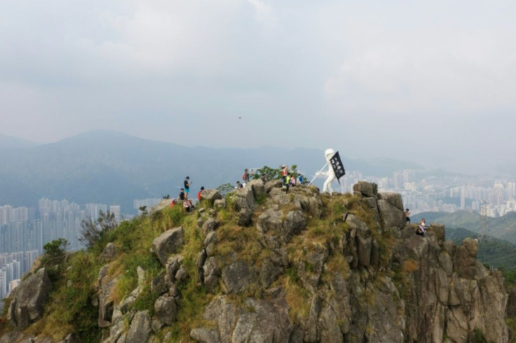 Volunteers used the cover of night to carry the 80 kilogram (180 pound) artwork up the steep path to the summit