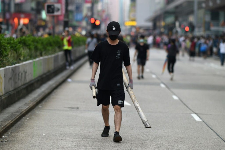 Rallies erupted in multiple Hong Kong neighbourhoods with some protesters blocking roads, throwing objects onto train tracks as well as spraying graffiti and smashing the windows of some pro-China businesses