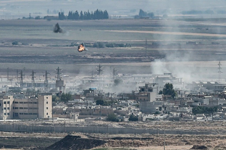 Rising smoke and explosions in the Syrian border town of Ras al-Ain as fighting rages along the border on the fifth day of a Turkish offensive in Kurdish-held northeast Syria