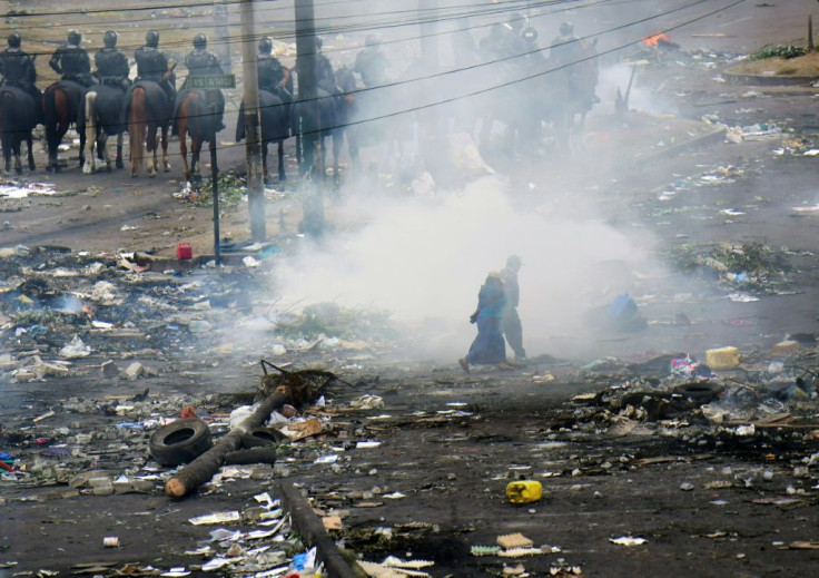 A man walks amid rubble, following a 10-day protest over a fuel price hike ordered by the government to secure an IMF loan, in Quito on October 13, 2019