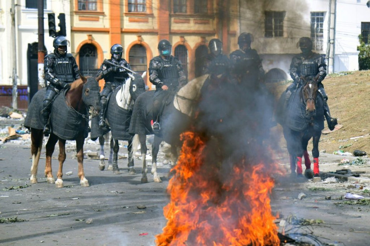 Ecuadorean riot policemen patrol the streets following a 10-day protest over a fuel price hike ordered by the government to secure an IMF loan, in Quito on October 13, 2019
