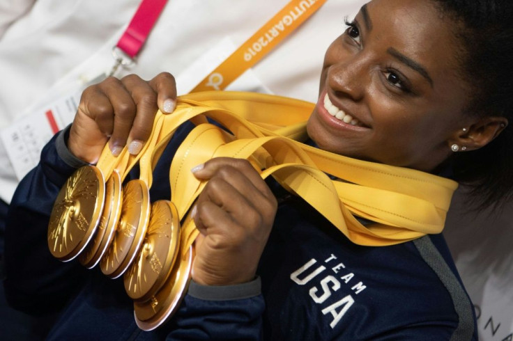 Simone Biles poses with her five gold medals at the world gymnastics championships in Stuttgart