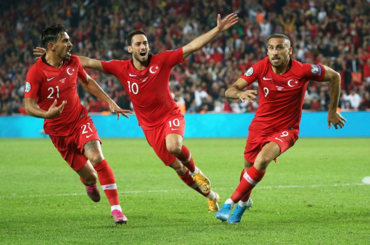 Turkey's forward Cenk Tosun (R) after scoring a late winner over Albania on Thursday