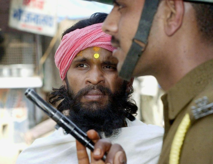For decades Hindus and Muslims have been bitterly divided over the 16th-century Babri mosque - here a sadhu, a Hindu holy man, is stopped from entering the disputed site in March 2002