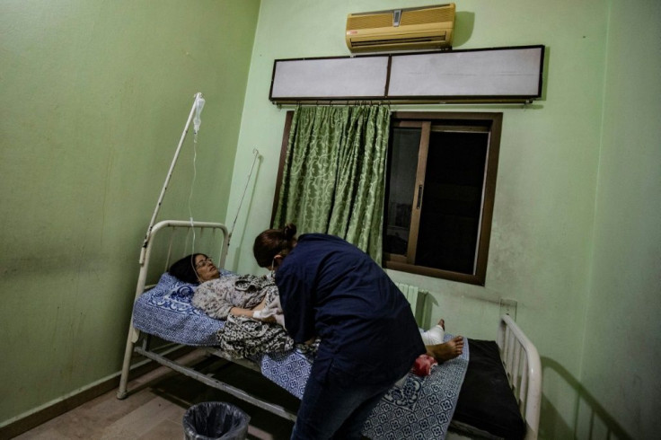 A wounded woman receives treatment at a hospital in Qamishli
