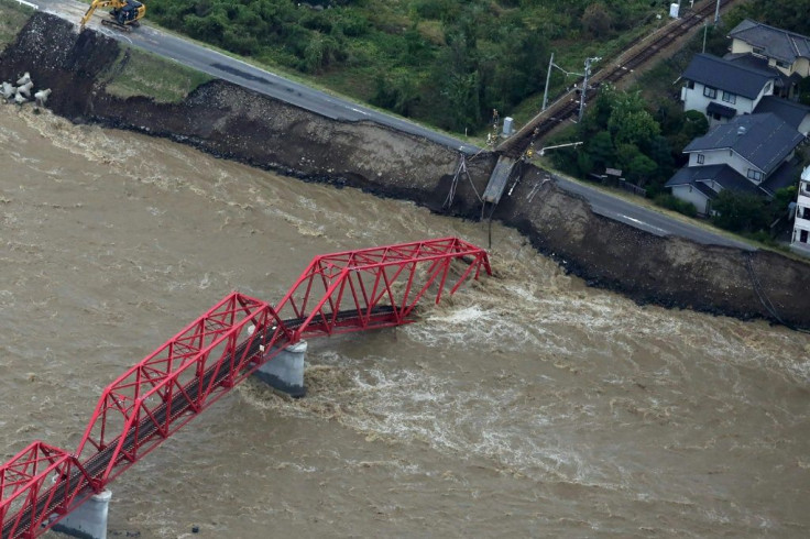 The Chikuma river, heavily swollen by rain from Typhoon Hagibis, swept away part of a train bridge in Ueda, in Japan's Nagano prefecture