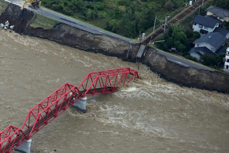 The Chikuma river, heavily swollen by rain from Typhoon Hagibis, swept away part of a train bridge in Ueda, in Japan's Nagano prefecture