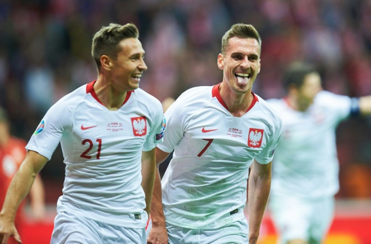 Chicago Fire player Przemyslaw Frankowski (L) made the crucial breakthrough for Poland