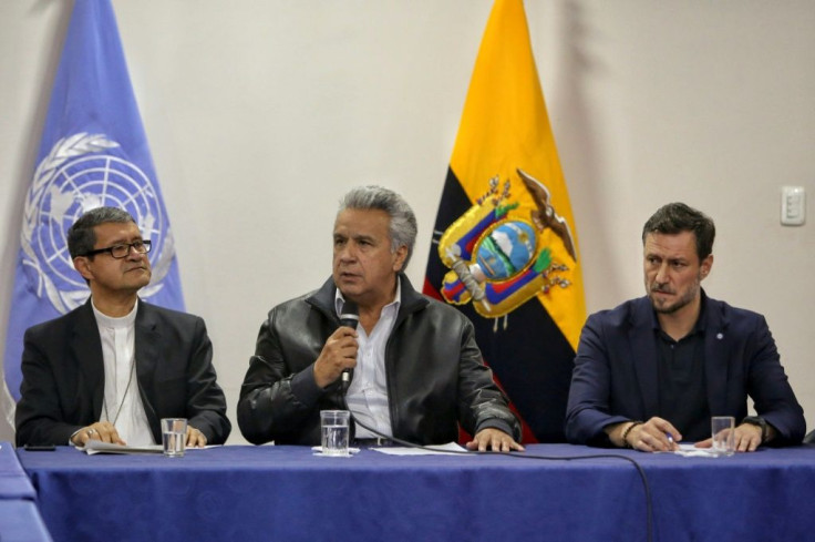 Ecuador's President Lenin Moreno (C) speaks flanked by Archbishop Luis Gerardo Cabrera Herrera (L) and United Nations representative Arnaud Perald during talks with indigenous leaders in Quito on October 13, 2019