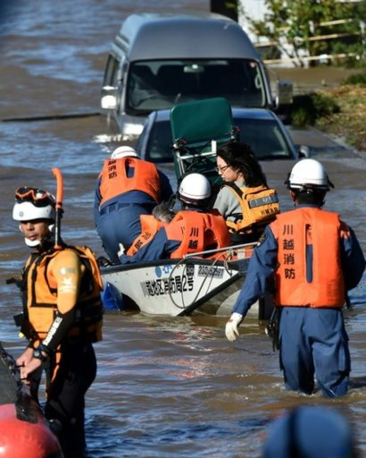 Rescue workers in Japan used boats and helicopters to reach people trapped after Typhoon Hagibis