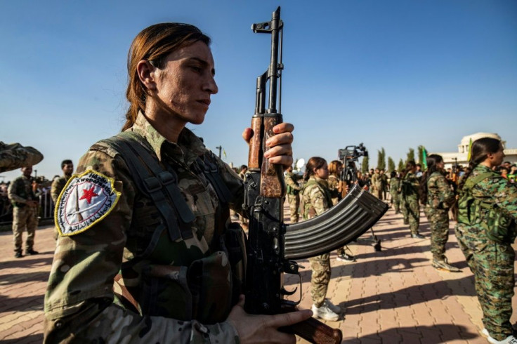 Kurdish forces attend a funeral for a political leader and others killed in the Turkish offensive