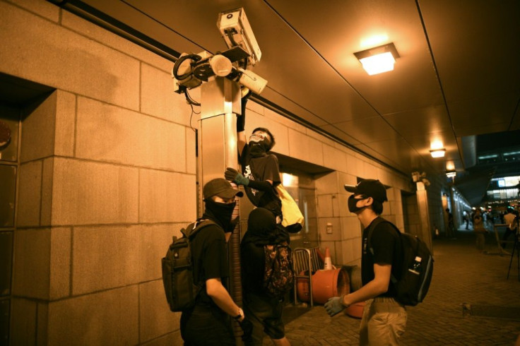 Hardcore protesters in Hong Kong vandalise security cameras during a rally in support of proposed US legislation