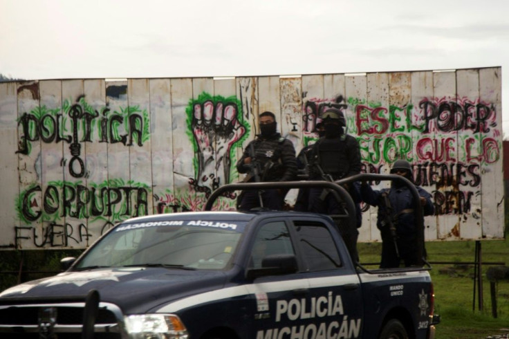 In a file photo from 2018, Mexican police in Michoacan state, where 14 officers were killed in an ambush on October 14, 2019