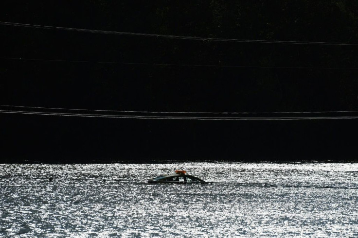 A car is barely visible, trapped by floodwaters in the aftermath of Typhoon Hagibis in Kakuda, Japan's Miyagi prefecture