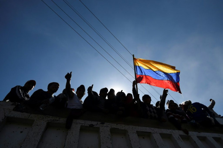 Indigenous protesters wave the Ecuador flag in celebration after the president and protest leaders reached an agreement