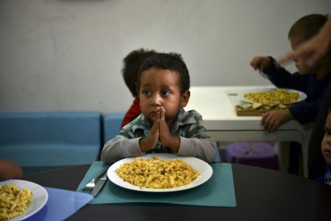 A child prays before eating at the Kapuy Foundation shelter which supports children abandoned, or with serious health problems, including undernourishment in Venezuela