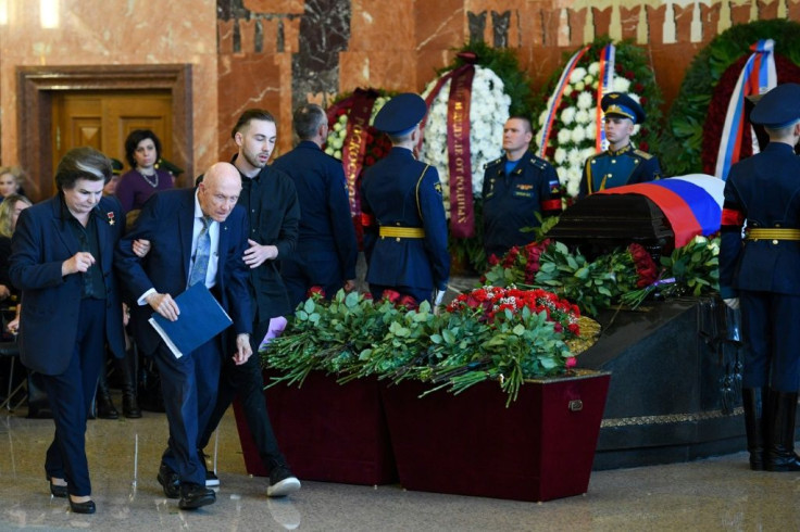 Former NASA astronaut Tom Stafford, assisted by Soviet cosmonaut Valentina Tereshkova, paid tribute to friend and colleague Leonov