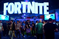 In this file photo taken on June 12, 2018, people crowd the display area for the survival game Fortnite at the 24th Electronic Expo, or E3 2018, in Los Angeles