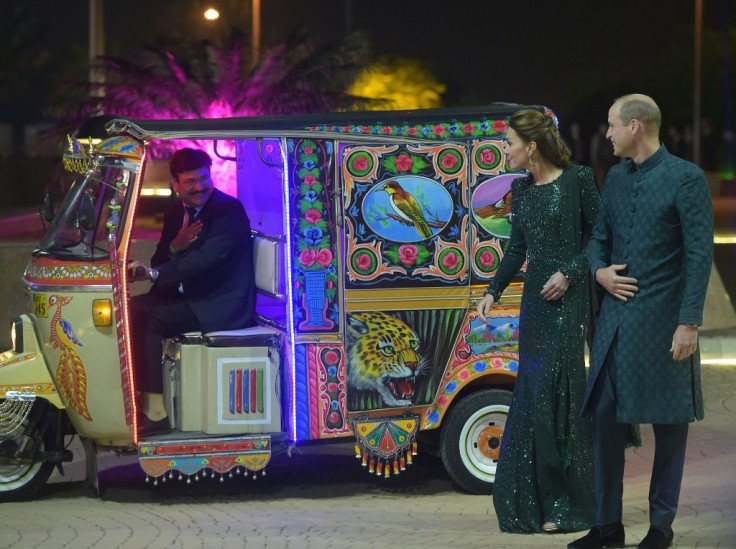Britain's Prince William (R), Duke of Cambridge, and his wife Kate arrived in an auto-rickshaw for a reception in Islamabad