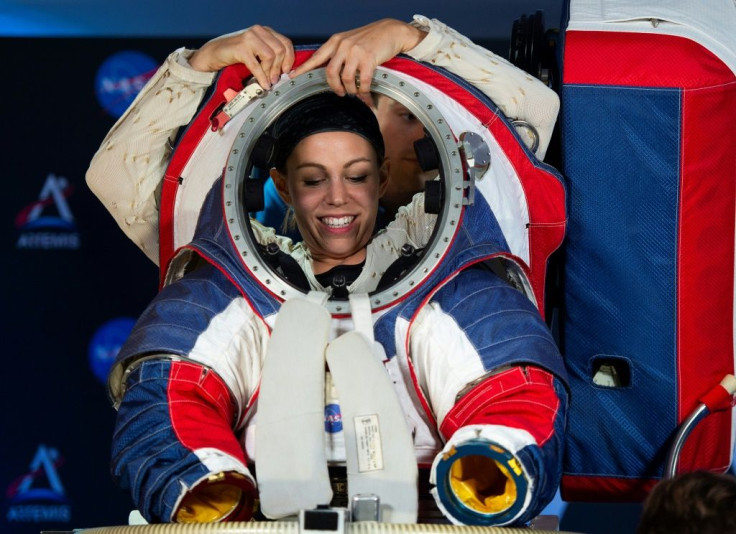 Advance space suit engineer, Kristine Davis, is helped out of a space suit after a press conference displaying the next generation of space suits as parts of the Artemis program in Washington