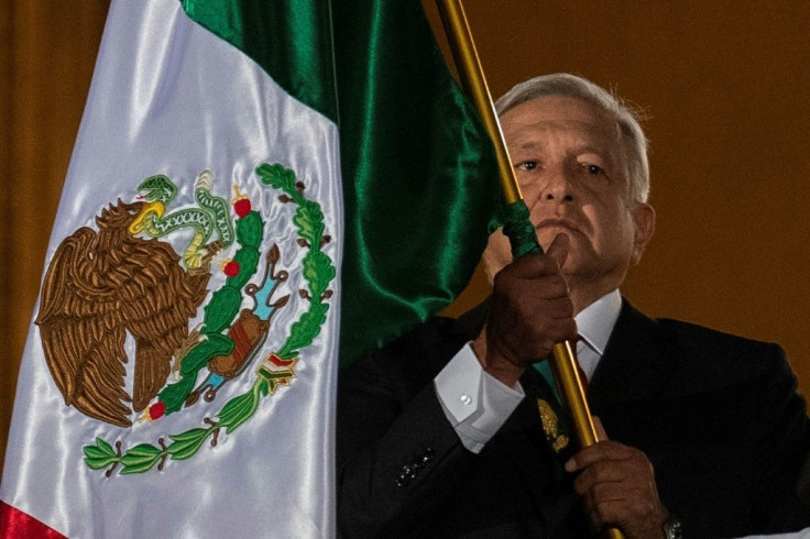 Mexican President Andres Manuel Lopez Obrador waves a Mexican flag at Independence Day celebrations in Mexico City on September 15, 2019