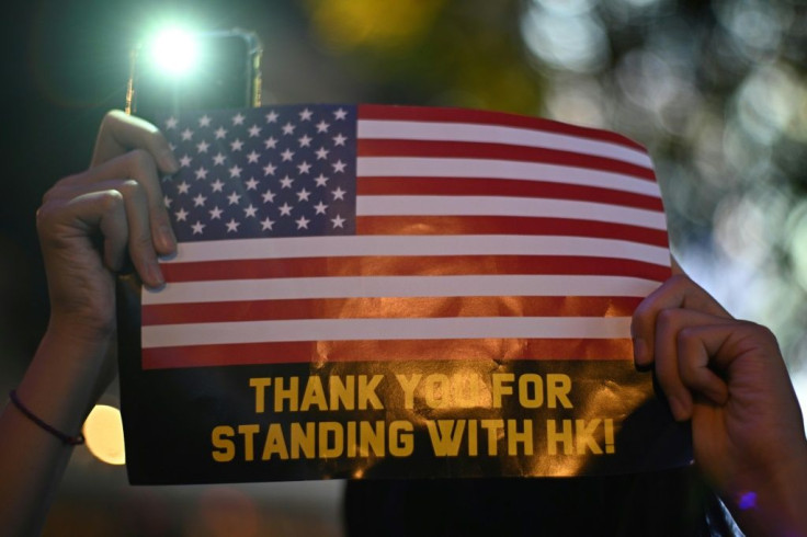 A protester holds a sign during a rally in Hong Kong calling on US politicians to pass Hong Kong Human Rights and Democracy Act