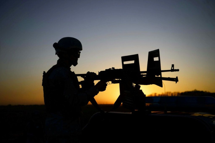 An Afghan National Security Forces soldier mans a machinegun mounted on a vehicle while patrolling in Guzara, Herat province