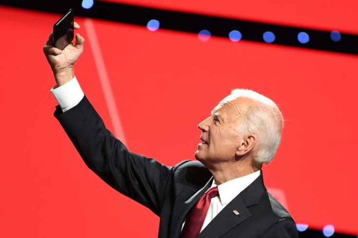 Democratic presidential hopeful Joe Biden, the former US vice president, takes a selfie with supporters after the fourth Democratic primary debate of the 2020 campaign season