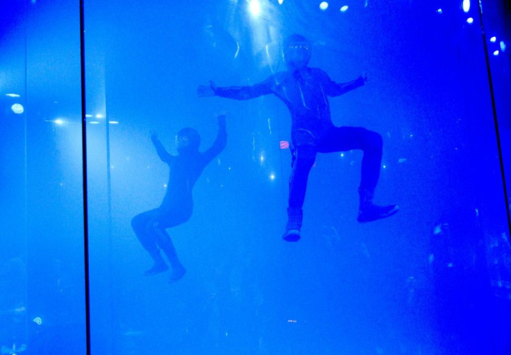 Models demonstrate Virgin Galactic's new space flight suits in a skydiving simulator October 16, 2019