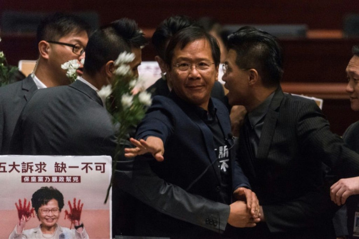 Hong Kong pro-democracy lawmaker Kwok Ka-ki (C) is removed by security from the Legislative Council after protesting as Chief Executive Carrie Lam held a question and answer session
