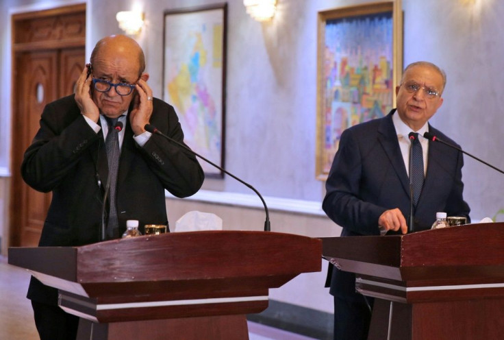 Iraqi Foreign Minister Mohammed Ali al-Hakim (R) and his French counterpart Jean-Yves Le Drian give a press conference in Baghdad on October 17, 2019