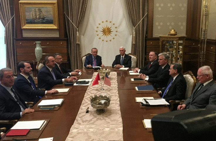 Turkish President Recep Tayyip Erdogan (C-L) and US Vice President Mike Pence (C-R), joined by Secretary of State Mike Pompeo (4R), Turkish Vice President Fuat Oktay (4L), Turkish Foreign Minister Mevlut Cavusoglu (3L) and senior aides, meet at the presid