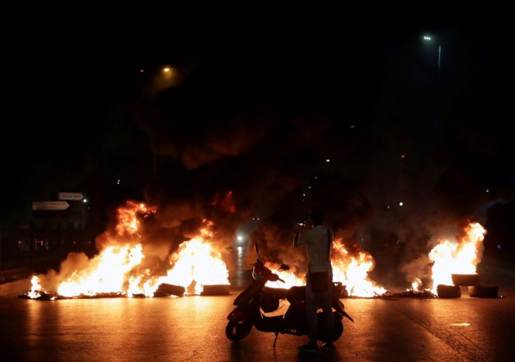 Protesters burned tyres as hundreds of people took to the streets in anger over a move to tax calls on messaging apps