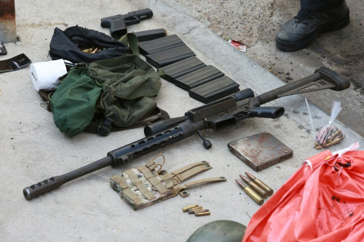 A gun, money bag and other items seized from criminals who raided the cargo terminal of the Viracopos International Airport, in Campinas, Sao Paulo state, Brazil, on October 17, 2019