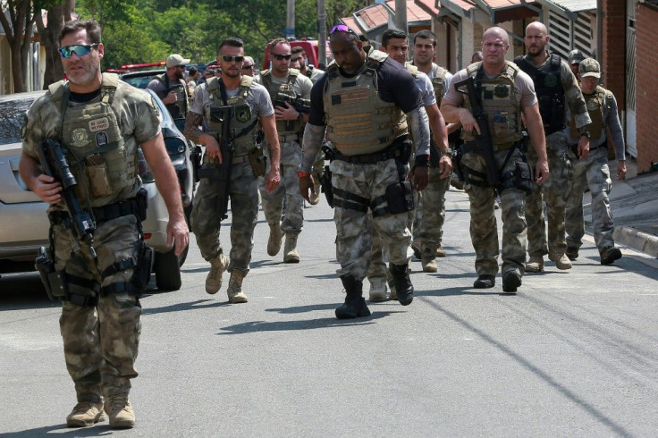 Police officers are photographed following the raid on the cargo terminal of the Viracopos International Airport, in Campinas, Sao Paulo state, Brazil, on October 17, 2019