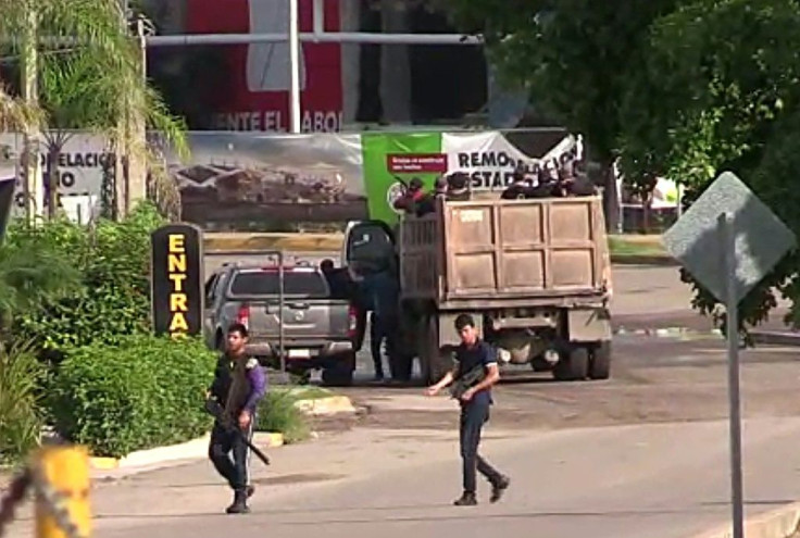 Armed gunmen are seen in a street of Culiacan, capital of jailed Mexican druglord Joaquin "El Chapo" Guzman's home state of Sinaloa, on October 17, 2019