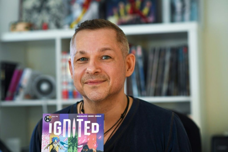 French comic book illustrator Phil Briones displays his comic book "Ignited," which tackles the politically controversial topic of mass shootings head-on, in his home office in Los Angeles