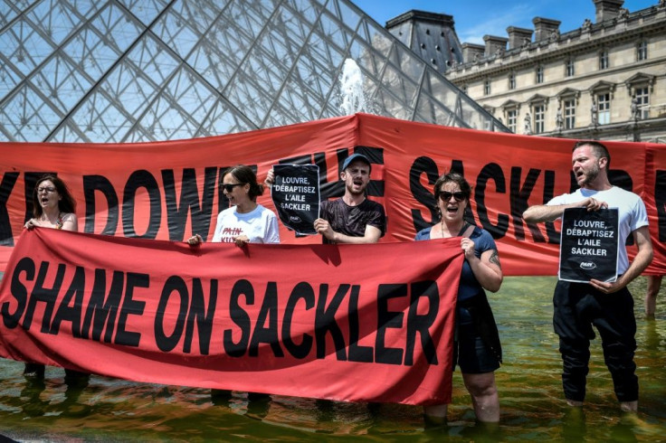 Activists outside the Louvre Museum in Paris protested on July 1, 2019 against the museum's links to the Sackler family, major philanthropists, because of their ownership of Purdue Pharma and links to the opioid crisis