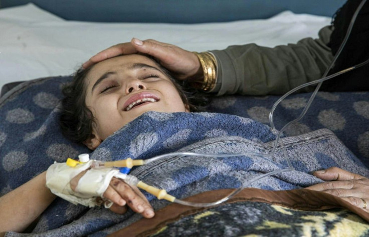 A girl wounded in the Turkish offensive against Kurdish-controlled northeastern Syria lies in a hospital bed in Tal Tamr, near the flashpoint border town of Ras al-Ain