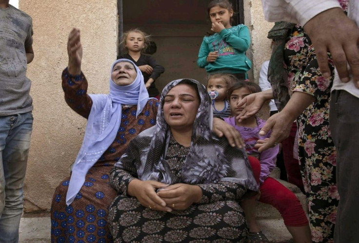 Women react during the Turkish offensive against Kurdish-controlled areas of northeastern Syria in Tal Tamr, near the Syrian Kurdish town of Ras al-Ain