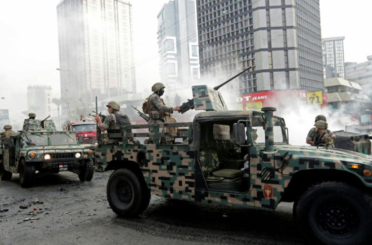 Lebanese soldiers arrive to open a road blocked by demonstrators during a protest against economic conditions in Baouchriyeh on the northern outskirts of Beirut