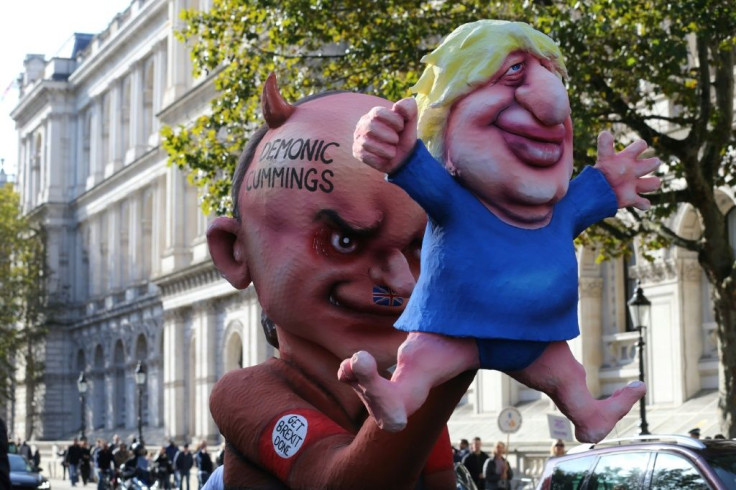 Demonstrators brandish an effigy depicting Britain's Prime Minister Boris Johnson as a puppet operated by his adviser Dominic Cummings during an anti-Brexit protest