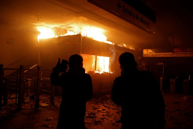 A metro station in Chile burns during protests triggered by a fare hike