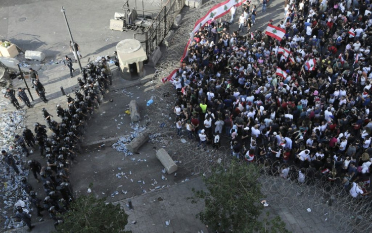 Lebanese security forces block a road as protesters rally in downtown Beirut