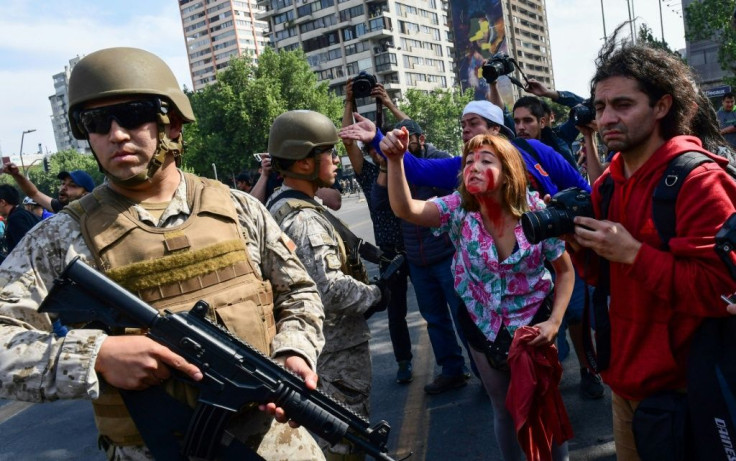 Protesters argue with Chilean soldiers during clashes in Santiago on October 19, 2019