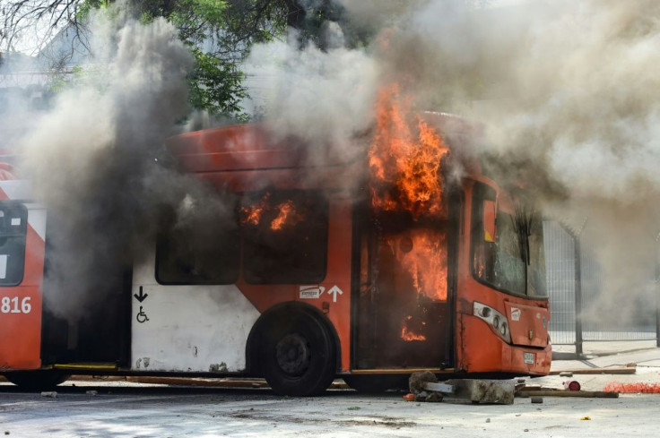 A bus burns during clashes between protesters and riot police in Santiago, Chile October 19, 2019